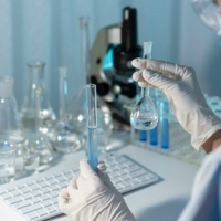 close-up-researcher-holding-glassware.jpg